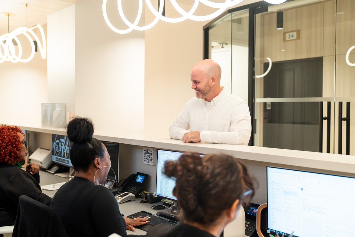 A patient checking in with the front desk team.